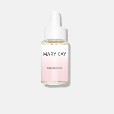 Closed bottle of Mary Kay Nourishing Oil standing against plain background.